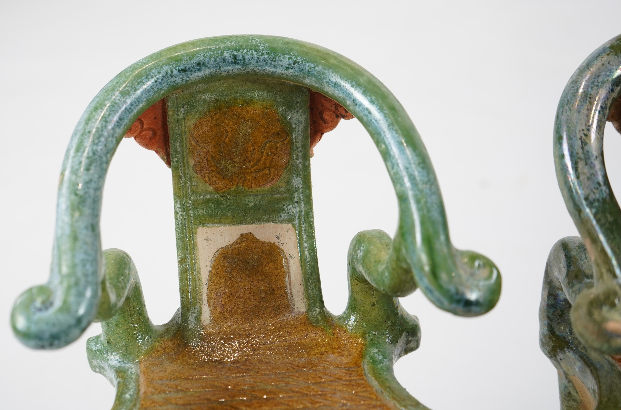 A set of Chinese Ming Sancai models of table with offerings and a pair of horseshoe shaped armchairs, 16th century